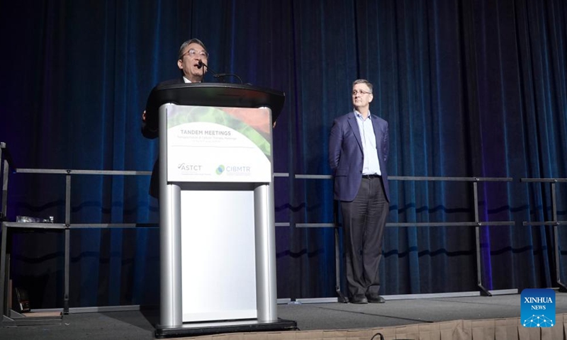 Huang Xiaojun (L) speaks after receiving the prestigious annual Center for International Blood and Marrow Transplant Research (CIBMTR) Distinguished Service Award during the 2024 Tandem Meetings in San Antonio, Texas, the United States, on Feb. 23, 2024. (Xinhua/Xu Jianmei)