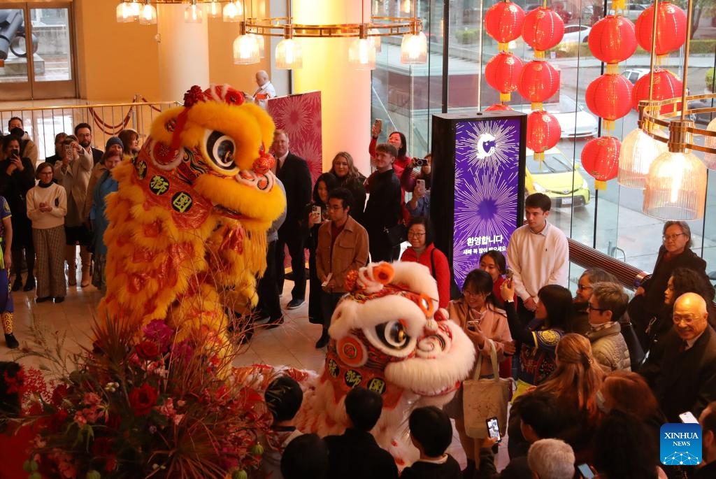 People watch a lion dance at Davies Symphony Hall in San Francisco, California, the United States, Feb. 17, 2024. A concert in celebration of the Chinese Lunar New Year was staged here by San Francisco Symphony on Saturday.(Photo: Xinhua)