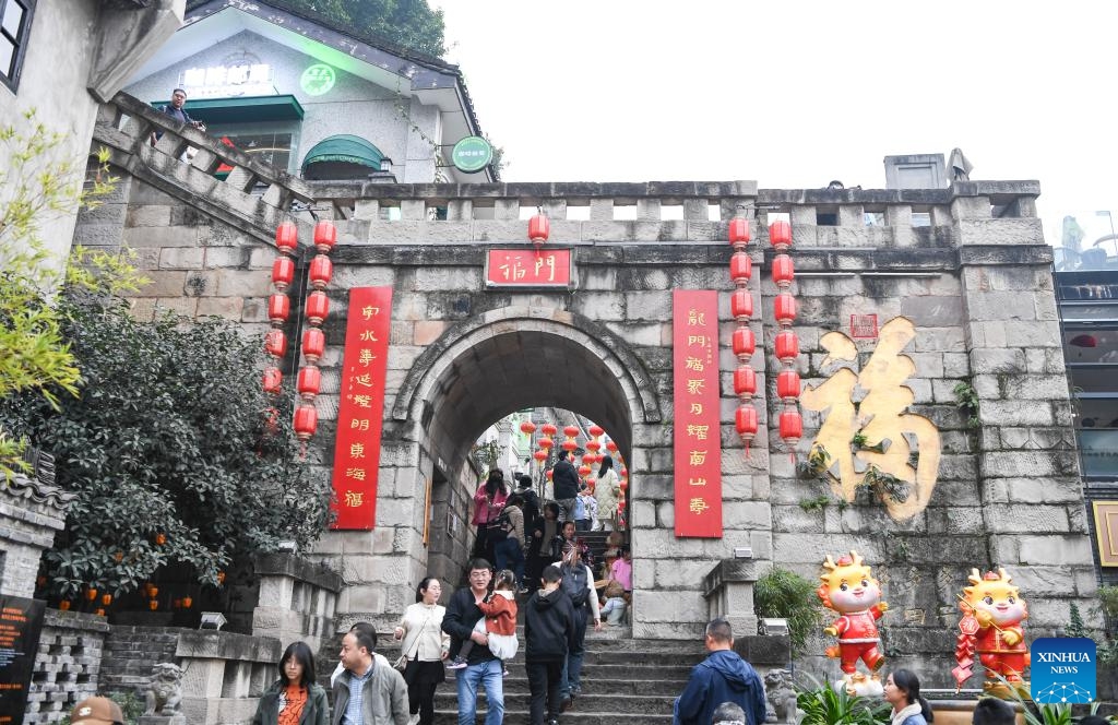 People visit Longmenhao old street in Nan'an District of southwest China's Chongqing Municipality, Feb. 14, 2024. In recent years, various urban renewal measures have been taken in Chongqing to transform old streets, old factories, old buildings into tourism attractions, the gathering place for emerging industries etc.(Photo: Xinhua)