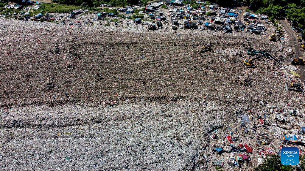 An aerial drone photo taken on Feb. 20, 2024 shows workers collecting plastic waste at Galuga landfill in Bogor, West Java, Indonesia.(Photo: Xinhua)