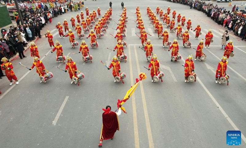 An aerial drone photo taken on Feb. 20, 2024 shows performers playing drums during a Shehuo show in Yuzhong County of Lanzhou, northwest China's Gansu Province. Shehuo, a traditional folk celebration in China, is a festivity in multiple forms consisting of dragon dance, lion dance, traditional Chinese opera, drum playing and other folk performances that may vary in different regions.(Photo: Xinhua)