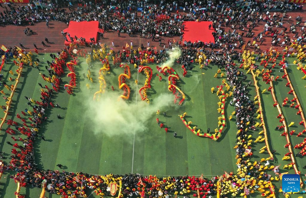 An aerial drone photo shows people watching dragon dance performance during the Maolong Festival of Gelao ethnic group in Shiqian County, southwest China's Guizhou Province, Feb. 20, 2024. The festival, as a folk activity for people of the Gelao ethnic group to celebrate the Spring Festival and lantern festival, is listed as one of the national intangible cultural heritages in 2006.(Photo: Xinhua)