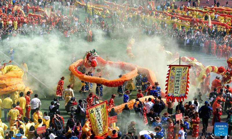 People watch a dragon dance competing event during the Maolong Festival of Gelao ethnic group in Shiqian County, southwest China's Guizhou Province, Feb. 20, 2024. The festival, as a folk activity for people of the Gelao ethnic group to celebrate the Spring Festival and lantern festival, is listed as one of the national intangible cultural heritages in 2006.(Photo: Xinhua)