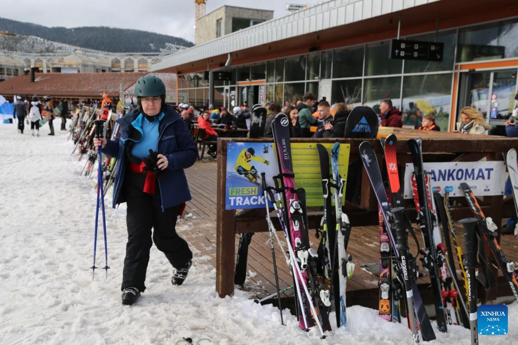 A visitor walks at a winter sports resort in Jasna, Slovakia, Feb. 21, 2024. Jasna greeted lots of visitors to enjoy skiing and snowboarding here in February.(Photo: Xinhua)