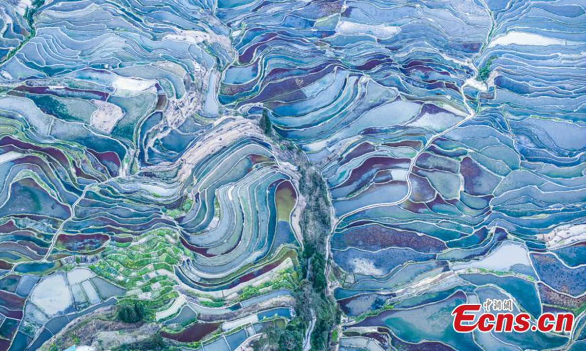 Spectacular aerial view of terraced fields at twilight in Yuanyang County of Honghe Hani and Yi Autonomous Prefecture, southwest China's Yunnan Province, Feb. 19, 2024. (Photo/VCG)