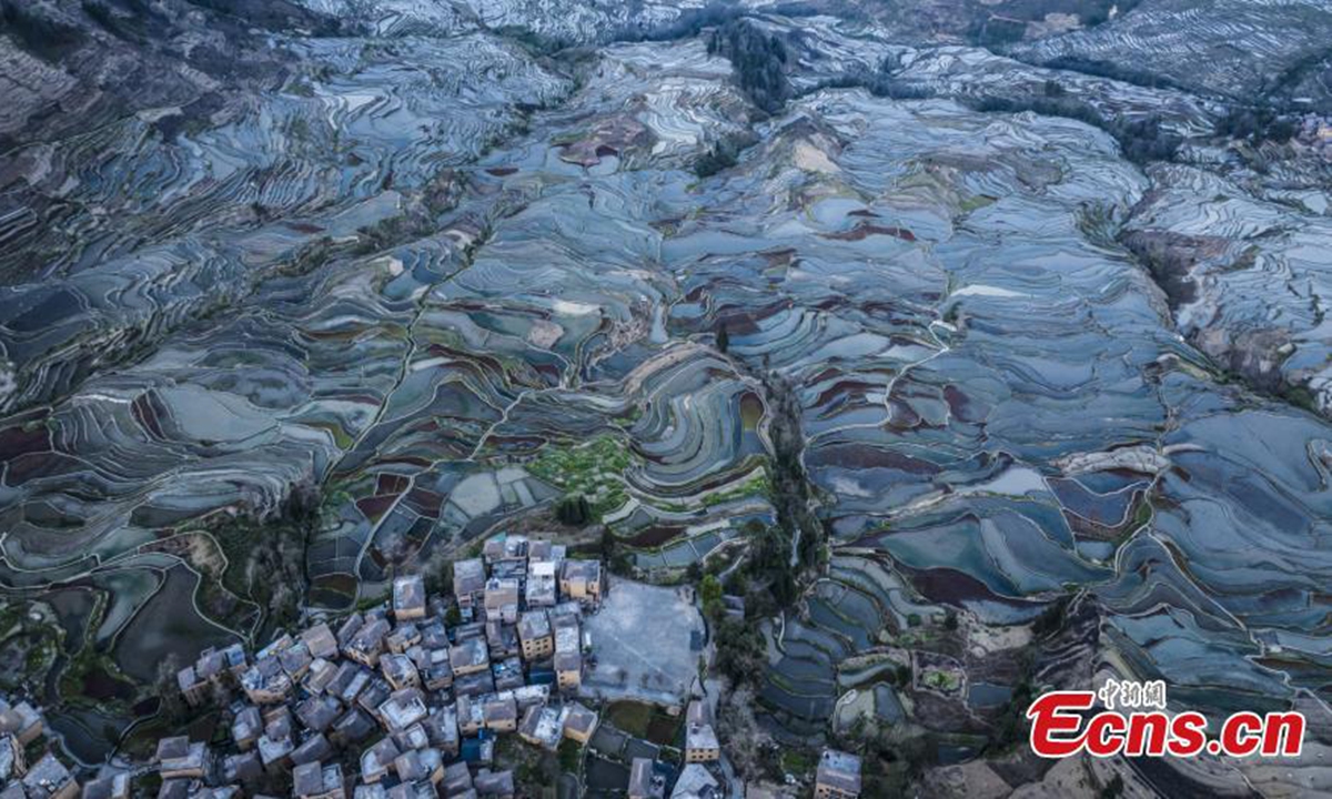 Spectacular aerial view of terraced fields at twilight in Yuanyang County of Honghe Hani and Yi Autonomous Prefecture, southwest China's Yunnan Province, Feb. 19, 2024. (Photo/VCG)