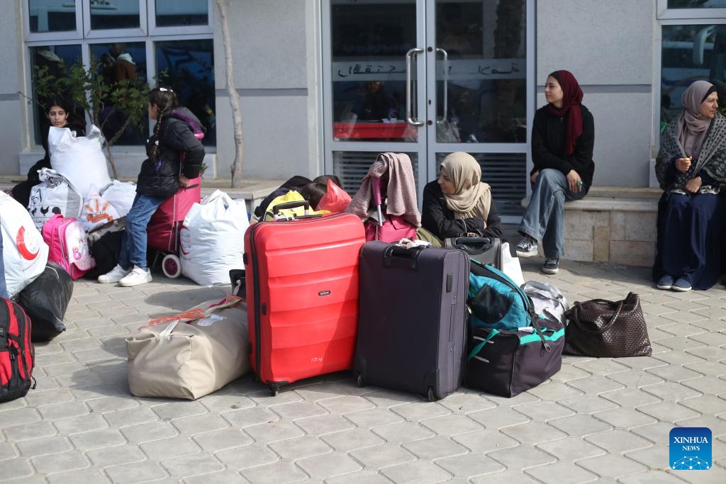 People wait to leave for Egypt via the Rafah crossing in the southern Gaza Strip, Feb. 25, 2024.(Photo: Xinhua)