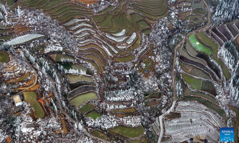 An aerial drone photo taken on Feb. 28, 2024 shows the snow scene in Dayuan Village of Quanzhou County, south China's Guangxi Zhuang Autonomous Region. Affected by a cold front, terraces in Dayuan Village were covered by ice and snow.(Photo: Xinhua)