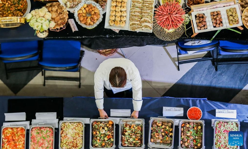 A chef prepares pork dishes as he participates in a Guinness World Record attempt during the National Hog Festival in Quezon City, the Philippines, on March 1, 2024. Hog farmers in Quezon City set the Guinness World Record for the most varieties of pork dishes on display during the launch of the five-day National Hog Festival on Friday. (Photo: Xinhua)