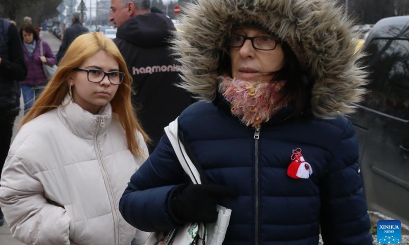 A woman wearing Martenitsa is seen in Sofia, Bulgaria, March 1, 2024. Bulgarian people marked the day named Baba Marta on Friday. On that day and a few days afterwards, Bulgarians exchange and wear the so-called Martenitsa - a small piece of adornment, made of white and red yarn. (Photo: Xinhua)