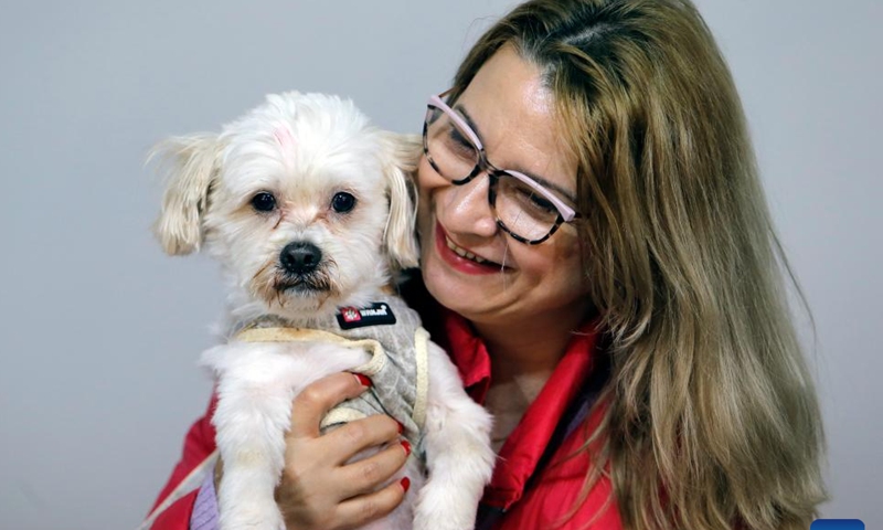 A woman poses for a photo with her dog at Pet Expo in Bucharest, Romania, March 16, 2024. The two-day expo kicked off here on Saturday. (Photo by Cristian Cristel/Xinhua)

