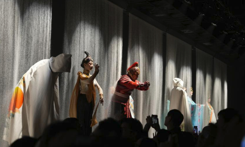 Spectators watch a drama in Dunhuang, northwest China's Gansu Province, March 16, 2024. Dunhuang has received a total of 336,000 tourists from Jan. 1 to March 16 this year, an increase of 86.6 percent over the same period in 2023. (Xinhua/Zhang Zhimin)