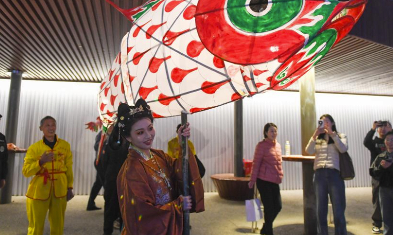 Tourists take photos of a fish-shaped lantern at an event along the Liangma River in Beijing, capital of China, March 16, 2024. A promotion event of the Liangma River was held on Saturday in Beijing.