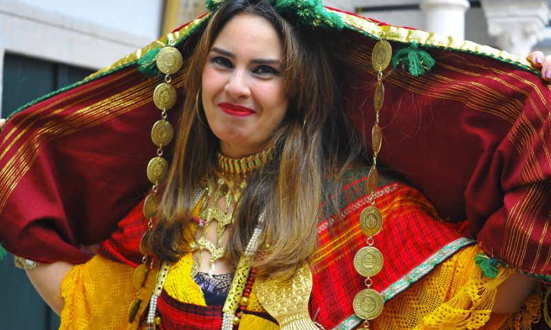 A woman dressed in traditional costume attends a celebration for the national day of traditional dress in Tunis, Tunisia, on March 10, 2024. (Photo by Adel Ezzine/Xinhua)