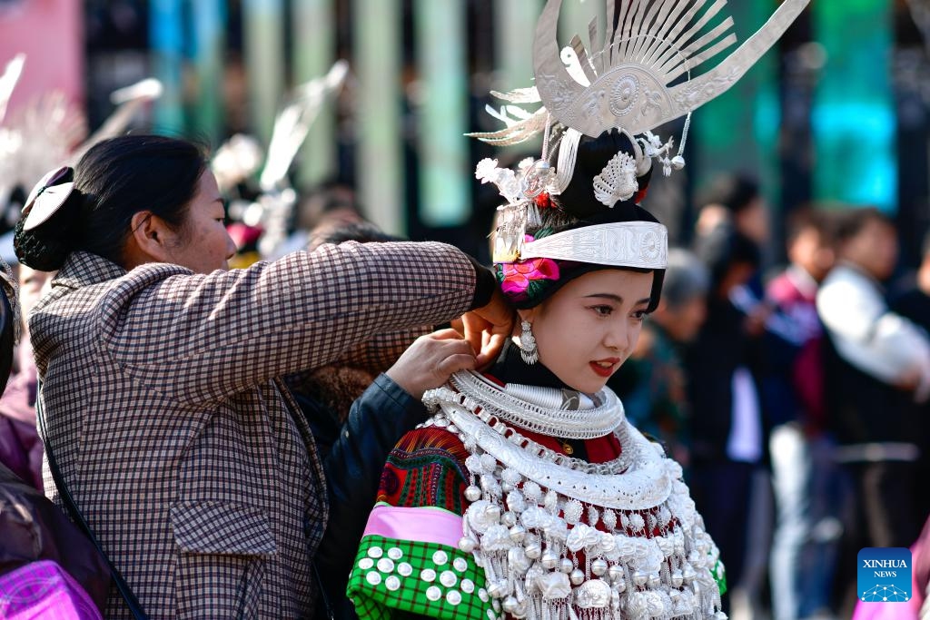 A woman of Miao ethnic group arranges silver ornaments for her daughter during the Gannangxiang festival in Kaili, Qiandongnan Miao and Dong Autonomous Prefecture, southwest China's Guizhou Province, March 2, 2024. In Kaili, local ethnic Miao people have the custom of donning their traditional attire and performing Lusheng, a traditional musical instrument, to rejoice in the annual Gannangxiang festival, a time-honored celebration in Guizhou Province. (Photo: Xinhua)