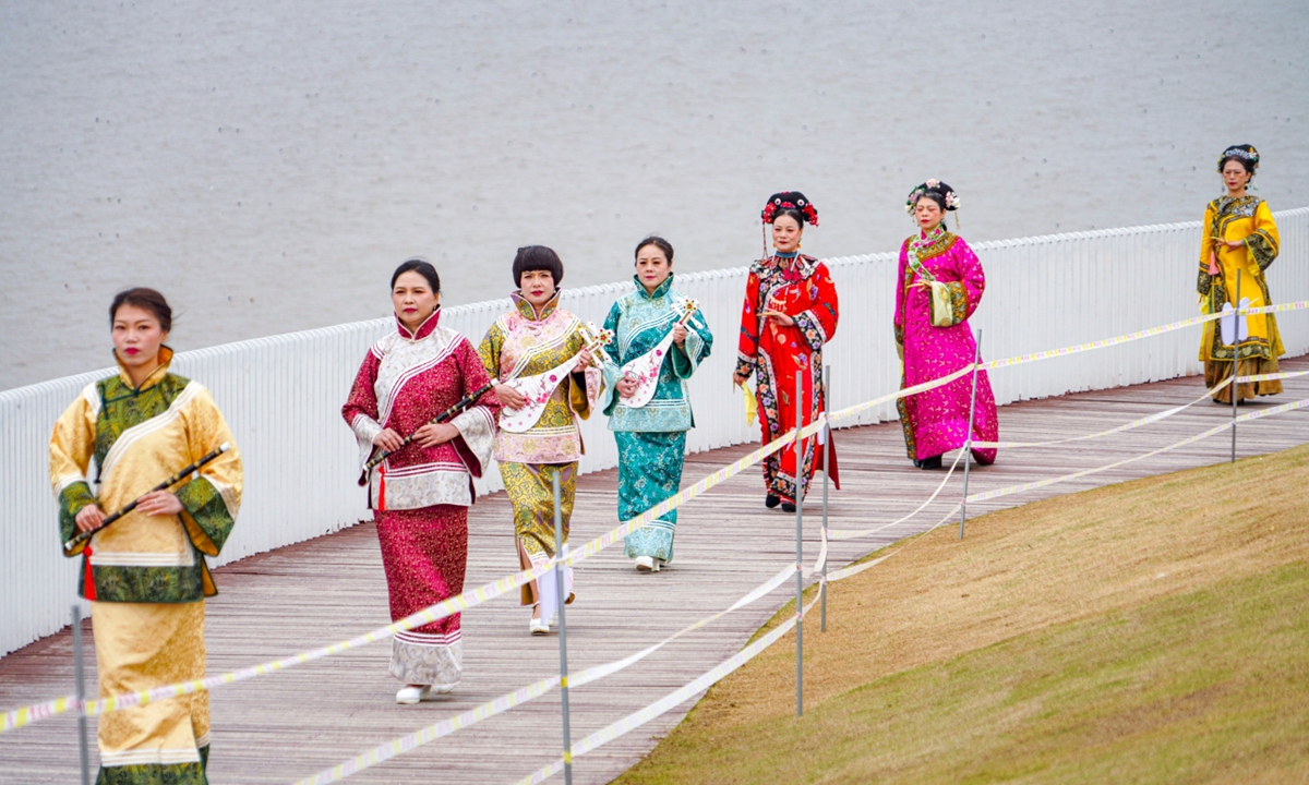 Women present cheongsam, also known as <em>qipao</em>, at a seaside scenic spot in Wenzhou, East China's Zhejiang Province, on March 6, 2024. <em>Qipao</em> is a traditional dress for Chinese women which takes inspiration from the ethnic clothing of the Manchu people. Evolving with the times, nowadays it represents a new fashion for Chinese women who value tradition and elegance. Photo: VCG