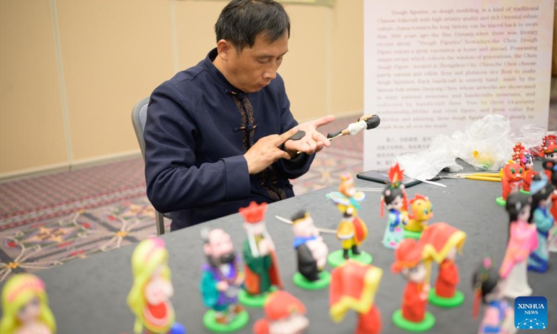 Chen Daoyong, a master of dough sculpture, makes dough figures at the Philadelphia Flower Show in Philadelphia, the United States, on March 2, 2024.(Photo: Xinhua)