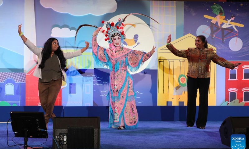 Visitors learn Chinese Peking Opera with an actress during the Events DC Embassy Chef Challenge in Washington, D.C., the United States, on March 7, 2024. More than 20 embassies competed in this year's Events DC Embassy Chef Challenge held at the Union Station in Washington, D.C. Thursday night, which captivated the audiences with unique flavors from across the world. (Xinhua)