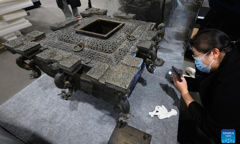 A staff member checks a bronze artifact at Hubei Provincial Museum in Wuhan, central China's Hubei Province, March 4, 2024. An exhibition titled Phoenix Kingdoms: The Last Splendor of China's Bronze Age will be held from April to July at the Asian Art Museum in San Francisco. The exhibition will feature over 260 artifacts from five Chinese museums, showcasing the art of the ancient Chu and Zeng states.(Photo: Xinhua)