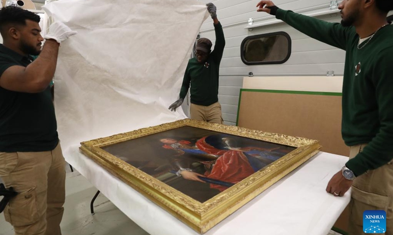 Staff members pack an exhibit at the Palace of Versailles in Paris, France, March 11, 2024. To celebrate the 60th anniversary of the establishment of diplomatic relations between France and China, the Palace of Versailles of France and the Palace Museum of China will jointly hold an exhibition from April to June at the Palace Museum in Beijing, which will display the history of exchanges between the two countries.(Photo: Xinhua)