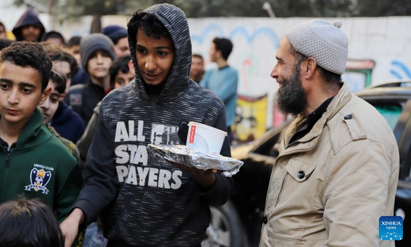 A man returns after receiving food relief during Ramadan in Gaza City, on March 13, 2024. The Palestinian death toll due to the ongoing Israeli attacks on the Gaza Strip has climbed to 31,272, reported the Gaza-based Health Ministry on Wednesday.(Photo: Xinhua)