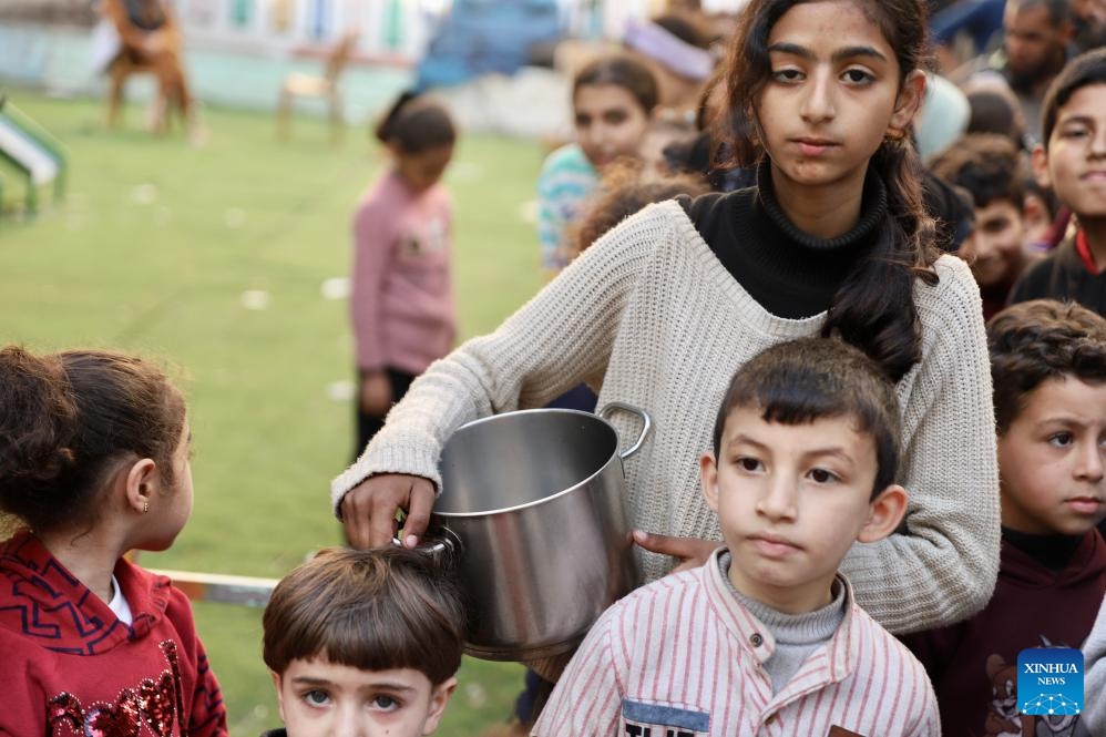 People wait to receive food relief during Ramadan in Gaza City, on March 13, 2024. The Palestinian death toll due to the ongoing Israeli attacks on the Gaza Strip has climbed to 31,272, reported the Gaza-based Health Ministry on Wednesday.(Photo: Xinhua)