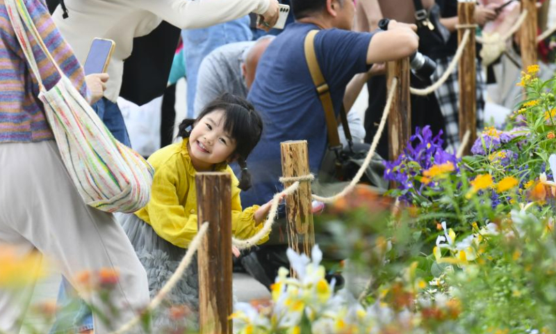 People visit the Greater Bay Area Flower Show in Shenzhen, south China's Guangdong Province, March 23, 2024. The Greater Bay Area Flower Show kicked off here on Saturday. Covering an exhibition area of more than 38,000 square meters, the event boasts 44 diverse gardens and will last until April 1. (Xinhua/Liang Xu)