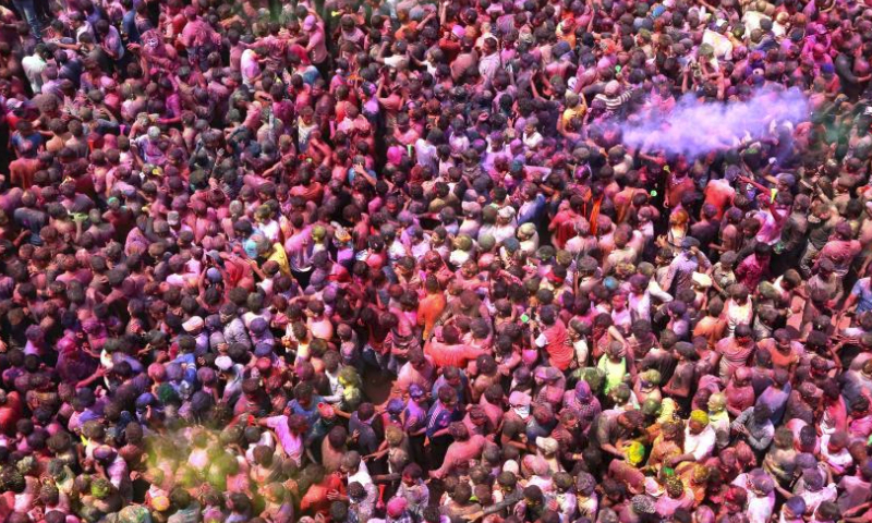 People smeared with colored powder take part in a celebration of the Rang Panchami festival in Indore, Madhya Pradesh state, India, March 30, 2024. (Str/Xinhua)