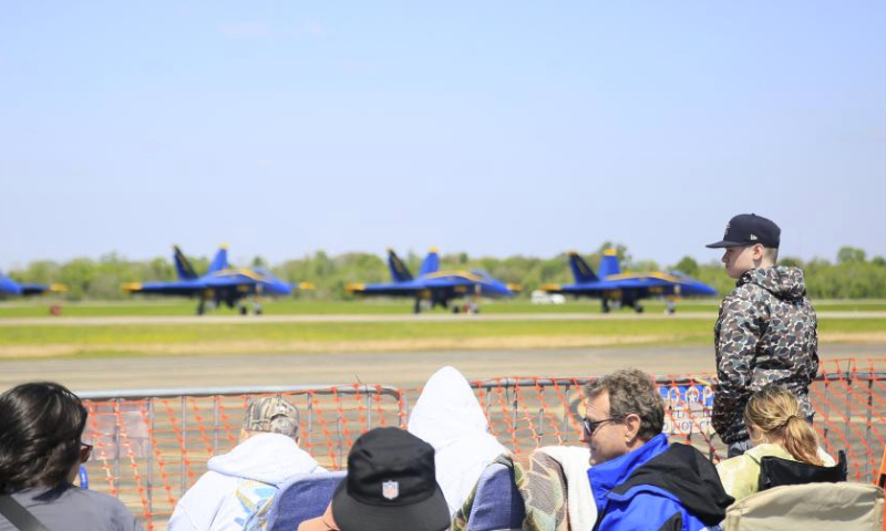 People watch the aerobatics show during the New Orleans Airshow at Naval Air Station Joint Reserve Base in Belle Chasse, Louisiana, the United States, March 23, 2024. (Photo by Lan Wei/Xinhua)