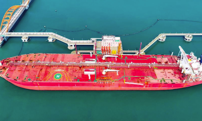 An aerial drone photo taken on March 29, 2024 shows a vessel offloading fuel at an oil terminal of Lanshan Area of Rizhao Port in Rizhao, east China's Shandong Province. The cargo throughput of Rizhao Port saw year-on-year growth of 6.7 percent in the first quarter of this year, among which container throughput hiked by 15.3 percent year-on-year. (Xinhua/Guo Xulei)

