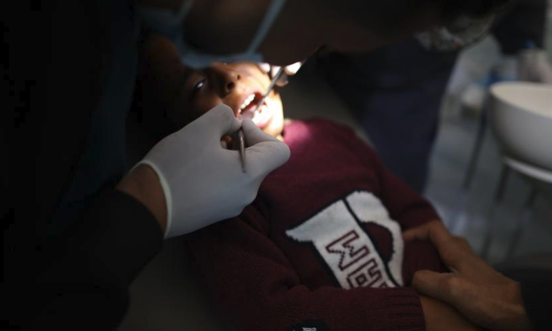 A dentist treats a patient at a temporary clinic in the Nuseirat refugee camp, central Gaza Strip, March 30, 2024. (Xinhua)