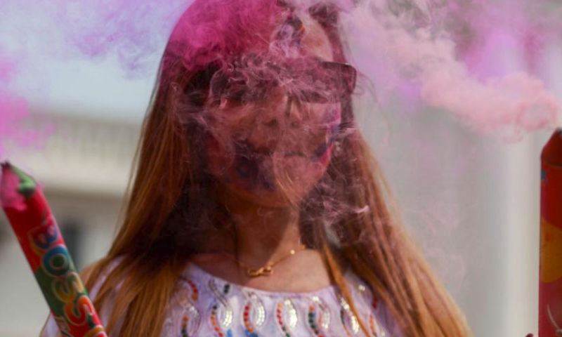 A woman is seen during the celebration of the Holi Festival at the Basantapur Durbar Square in Kathmandu, Nepal, March 24, 2024. Holi, the festival of colors, marks the beginning of the spring season. (Photo by Sulav Shrestha/Xinhua)