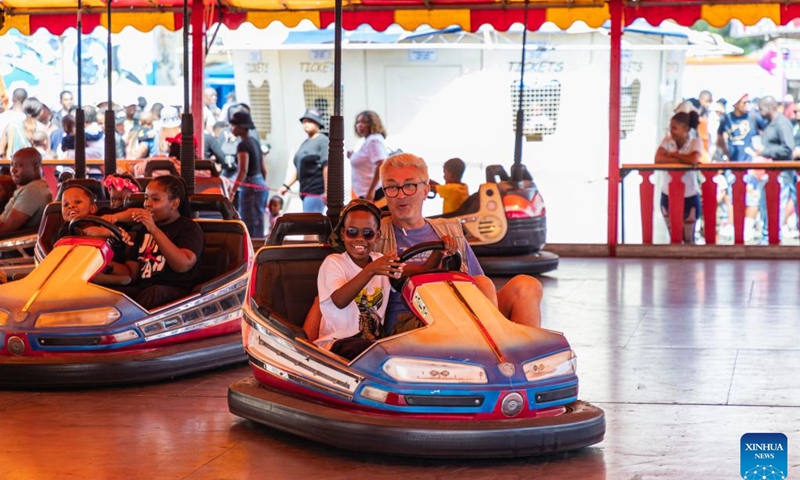 Visitors enjoy a bumper car ride during the Rand Show 2024 in Johannesburg, South Africa, March 30, 2024. The Rand Show 2024, the annual entertainment and shopping extravaganza in South Africa, is held from March 28 to April 1 at the Johannesburg Expo Center. (Xinhua/Zhang Yudong)