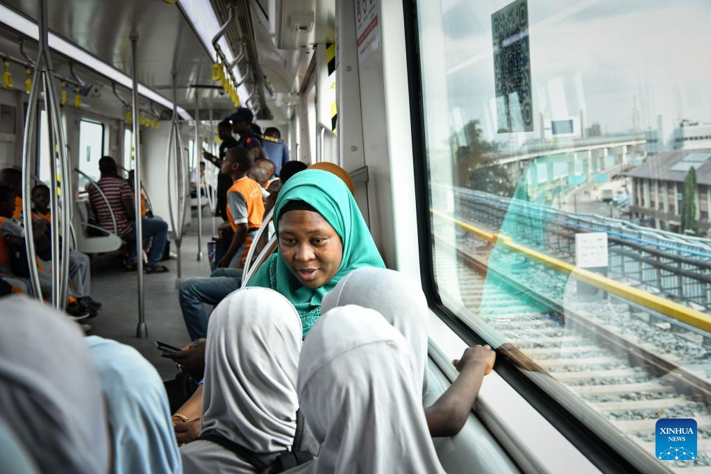 Teachers and students take a train of the Lagos Rail Mass Transit (LRMT) Blue Line in Lagos, Nigeria, Feb. 28, 2024. Undertaken by China Civil Engineering Construction Corporation (CCECC) in July 2010 and completed in Dec. 2022, the first phase of the Lagos Rail Mass Transit (LRMT) Blue Line corridor spans 13 km and covers five stations. It began commercial operation in Sept. of 2023.(Photo: Xinhua)