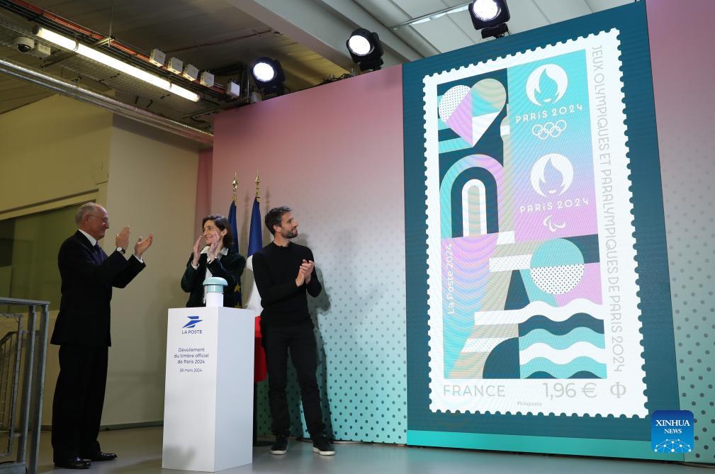 Chief Executive Officer of La Poste Group Philippe Wahl, French Sports Minister Amelie Oudea-Castera and President of the Paris 2024 Organizing Committee Tony Estanguet (L to R) unveil the official stamp for the Paris 2024 Olympic and Paralympic Games during a presentation at the French Postal Museum in Paris, France, March 26, 2024.(Photo: Xinhua)