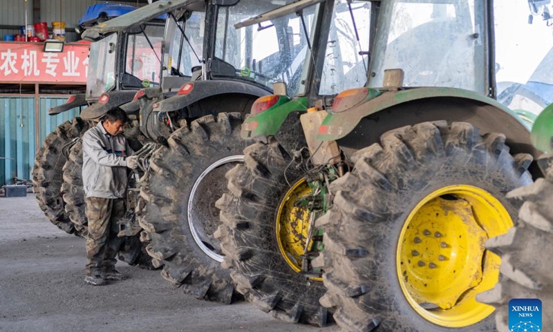 A worker maintains agricultural machinery at a cooperative for rice cultivation in Boli County, northeast China's Heilongjiang Province, April 3, 2024. China's major grain production province Heilongjiang, known as the country's grain barn, is conducting a wide range of activities to ensure a robust foundation for spring farming. (Xinhua/Xie Jianfei)