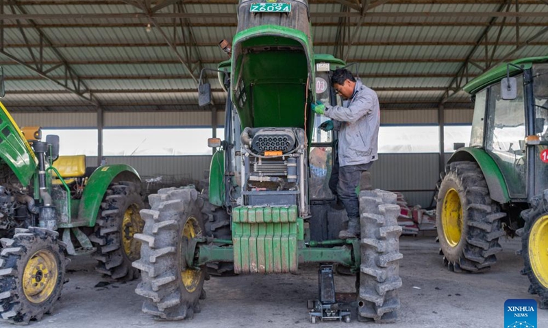 A worker maintains agricultural machinery at a cooperative for rice cultivation in Boli County, northeast China's Heilongjiang Province, April 3, 2024. China's major grain production province Heilongjiang, known as the country's grain barn, is conducting a wide range of activities to ensure a robust foundation for spring farming. (Xinhua/Xie Jianfei)