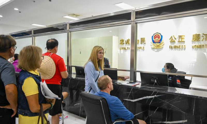 Foreign tourists apply for temporary entry permits at the Tianjin Dongjiang border inspection station in north China's Tianjin Municipality on April 7, 2024. Cruise ship Serenade of the Seas docked at Tianjin International Cruise Home Port in north China's port city of Tianjin on Sunday morning, with over 1,800 tourists from 50 countries and regions aboard.(Xinhua/Sun Fanyue)