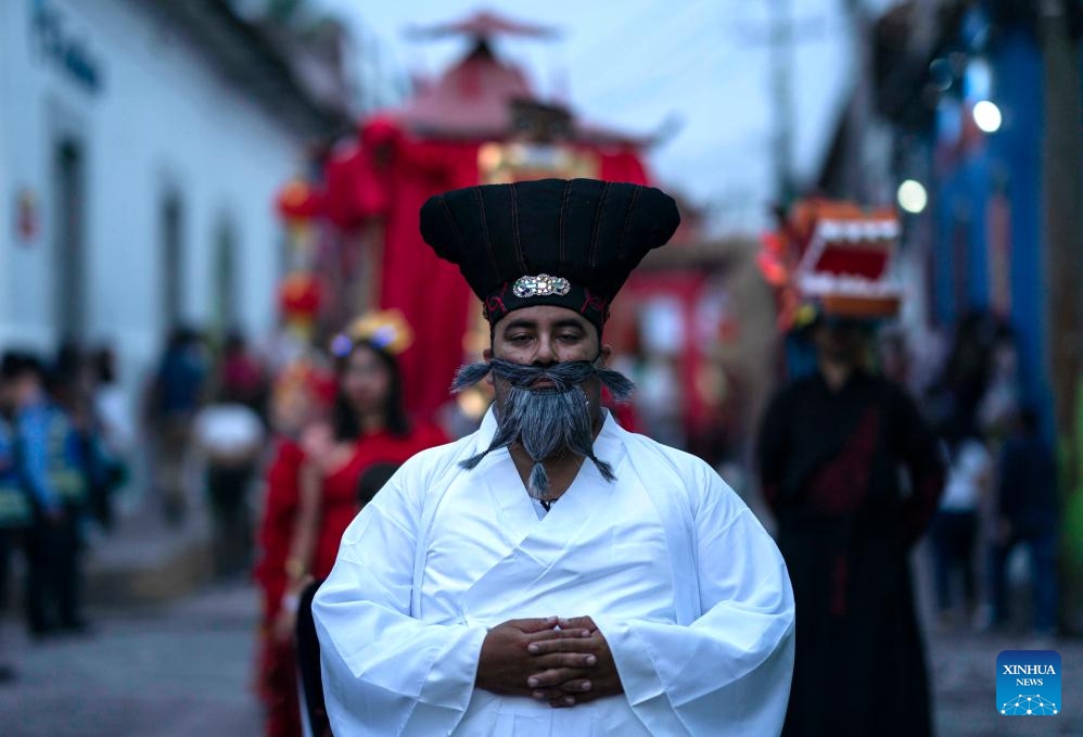 People take part in the parade of Living Fire Festival, themed on Chinese culture this year, in Santa Rosa de Copan, Honduras, on April 5, 2024.(Photo: Xinhua)