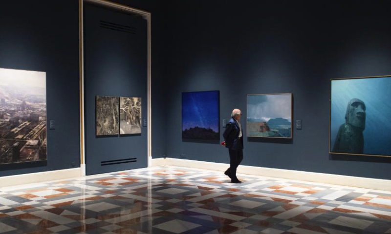 A visitor views an exhibition featuring contemporary oil paintings from China and Spain at Palacio Real, in Madrid, Spain, on April 12, 2024. (Photo by Gustavo Valiente/Xinhua)