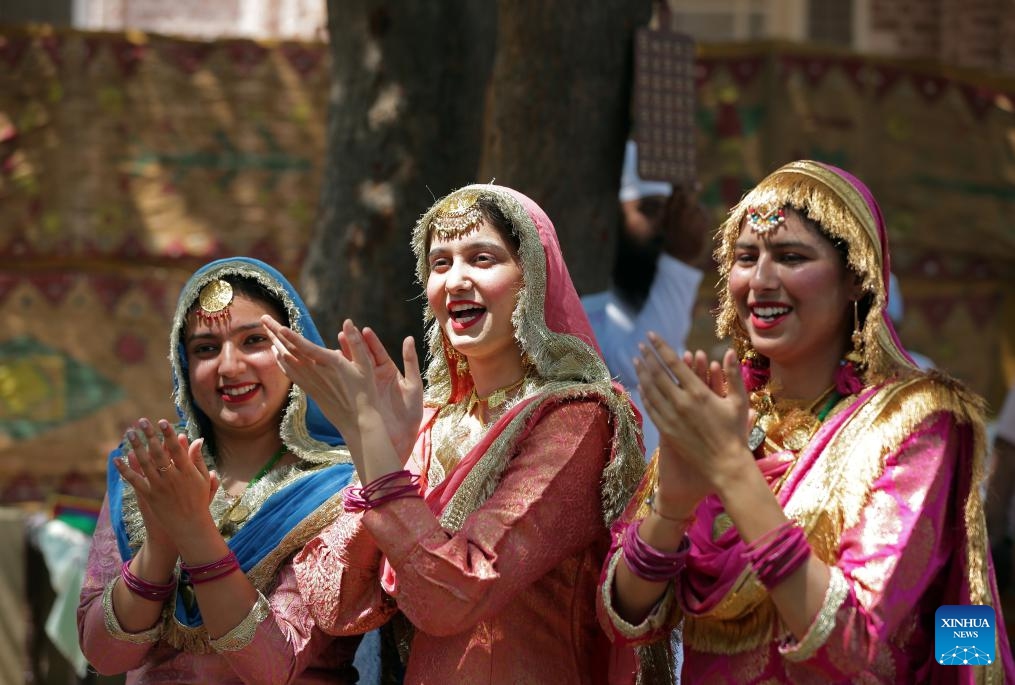 Women wearing traditional Punjabi attire sing folk songs during a fair celebrating the Baisakhi festival at a college in Amritsar district of India's northern Punjab state, April 9, 2024. Baisakhi is one of the most popular festivals celebrated in the Indian state of Punjab to mark the harvest.(Photo: Xinhua)