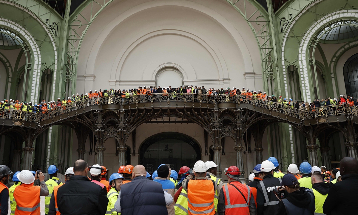 French President Emmanuel Macron addresses workers in charge of the renovation of the Grand Palais in Paris on April 15, 2024, 100 days ahead of the Paris 2024 Olympic Games. The Grand Palais will host the fencing and taekwondo competition events during the Paris 2024 Olympic Games. Photo: VCG