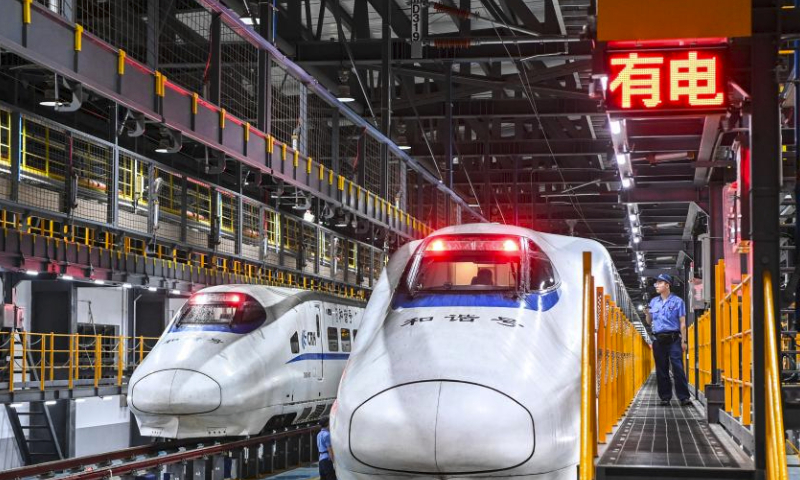 Staff members check the body of a bullet train at a train maintenance workshop in Nanning City, south China's Guangxi Zhuang Autonomous Region, May 1, 2024. International Workers' Day is observed annually on May 1. (Xinhua/Cao Yiming)