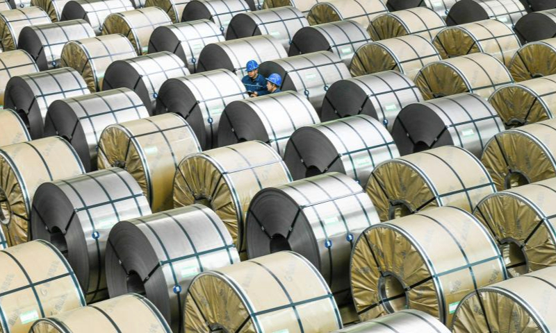 Staff members work at a warehouse of Ganglu Iron & Steel Co., Ltd. in Tangshan, north China's Hebei Province, May 1, 2024. International Workers' Day is observed annually on May 1. (Photo by Liu Mancang/Xinhua)