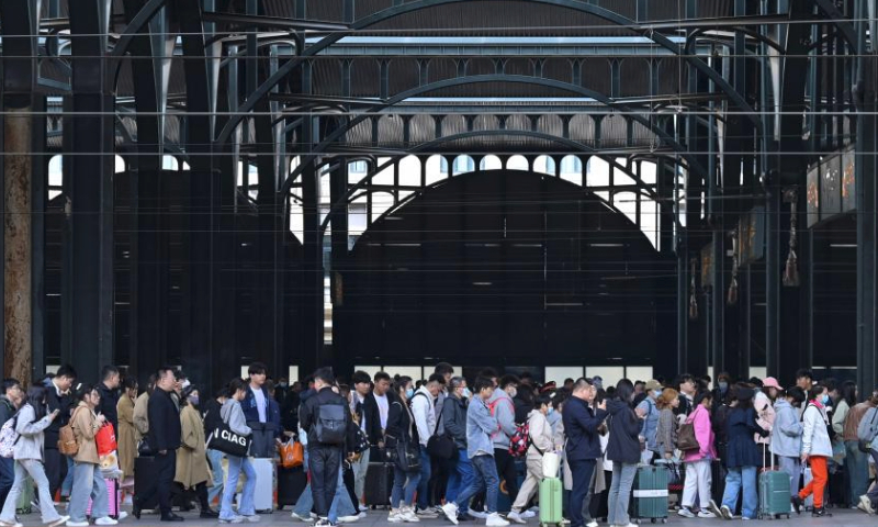 Passengers queue to enter Harbin Railway Station in Harbin, capital of northeast China's Heilongjiang Province, on April 30, 2024. China's railway network is expected to handle 144 million passenger trips during the eight-day May Day holiday travel rush, the China State Railway Group Co., Ltd. said Monday. (Photo by Yuan Yong/Xinhua)