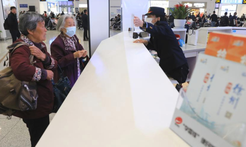 Passengers inquire information at the service desk of Xuzhou East Railway Station in Xuzhou, east China's Jiangsu Province, on April 30, 2024. China's railway network is expected to handle 144 million passenger trips during the eight-day May Day holiday travel rush, the China State Railway Group Co., Ltd. said Monday. (Xinhua/Mao Jun)