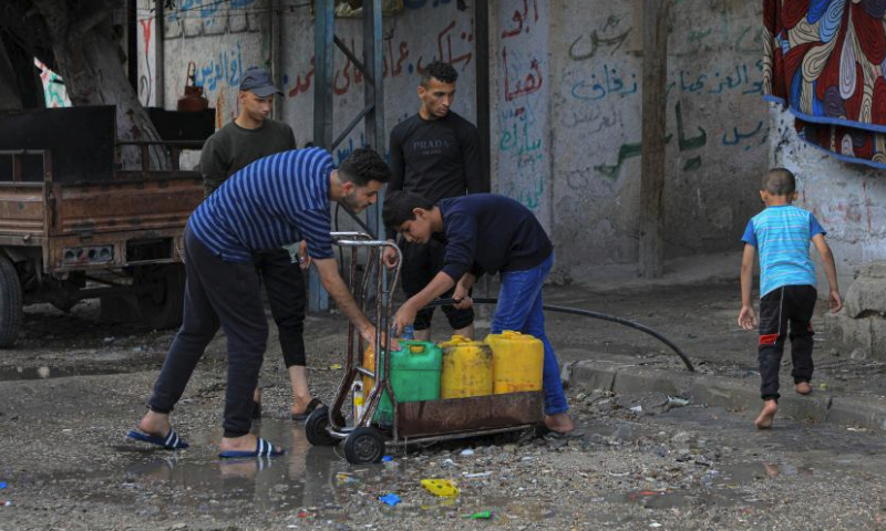 People fetch water in the southern Gaza Strip city of Rafah, on April 30, 2024. (Photo by Rizek Abdeljawad/Xinhua)