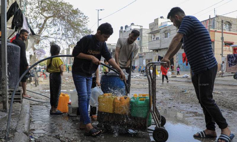 People fetch water in the southern Gaza Strip city of Rafah, on April 30, 2024. (Photo by Rizek Abdeljawad/Xinhua)