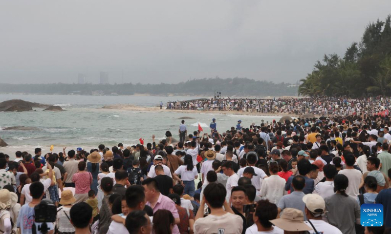 People wait to watch the launch of the Chang'e-6 lunar probe in south China's Hainan Province, May 3, 2024. A Long March-5 rocket, carrying the Chang'e-6 spacecraft, blasted off from its launchpad at the Wenchang Space Launch Site on the coast of China's southern island province of Hainan on Friday afternoon. (Xinhua/Jin Liwang)