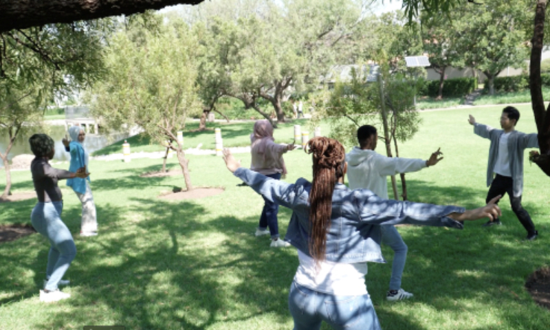 Hu Zijing practices Baduanjin with his students at the University of Johannesburg. Photo: Courtesy of Hu Zijing